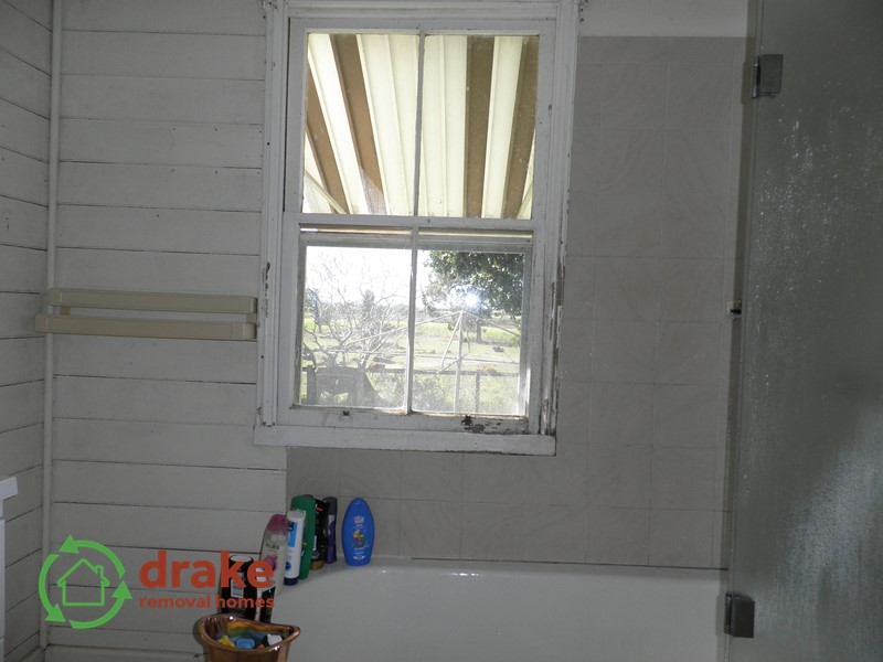 Old original colonial bathroom with bath and timber window